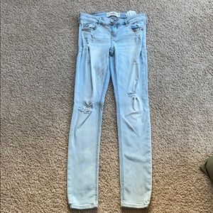 light blue jeans with holes